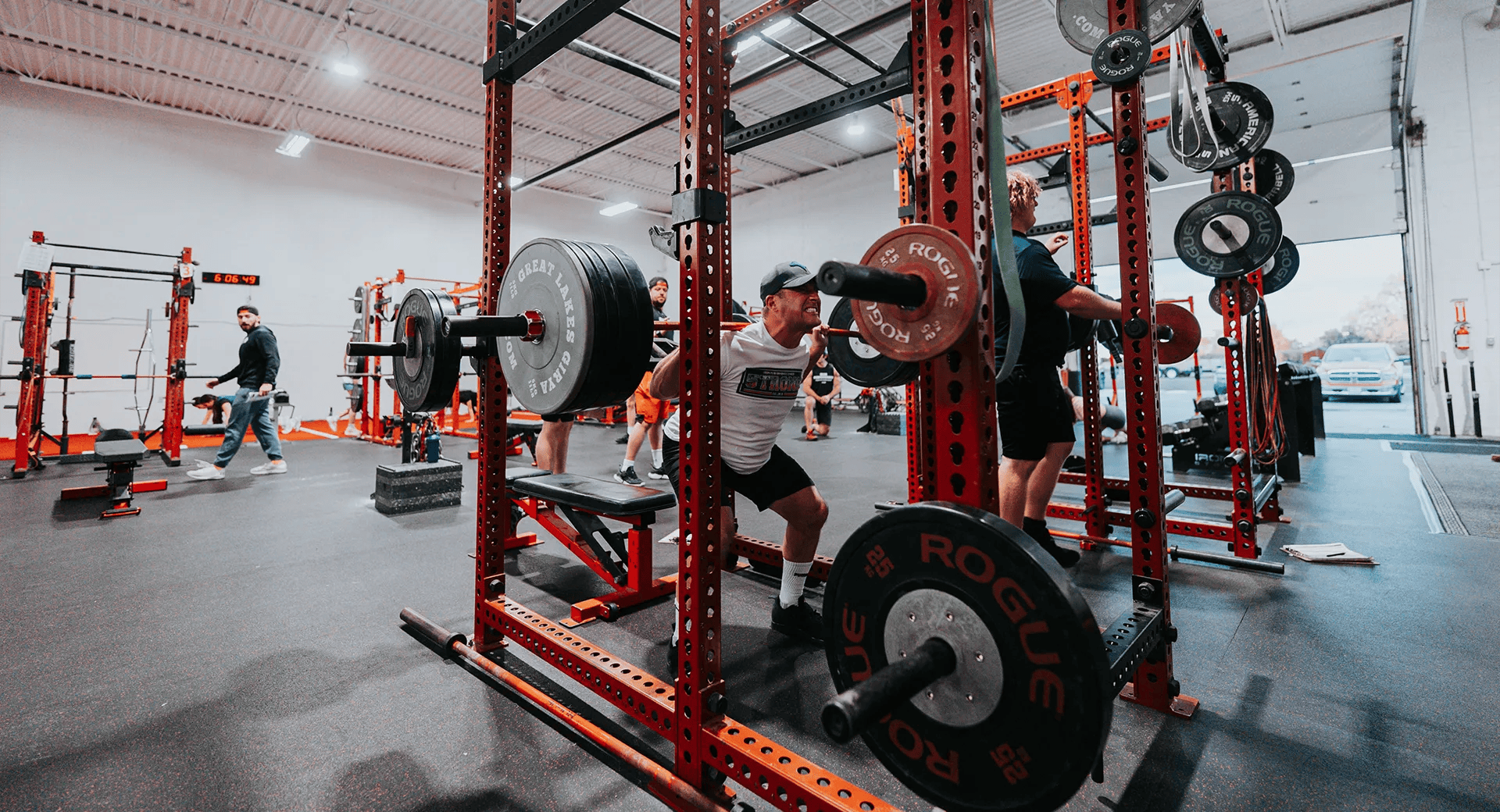 Man squatting heavy weight at Iron Performance Center